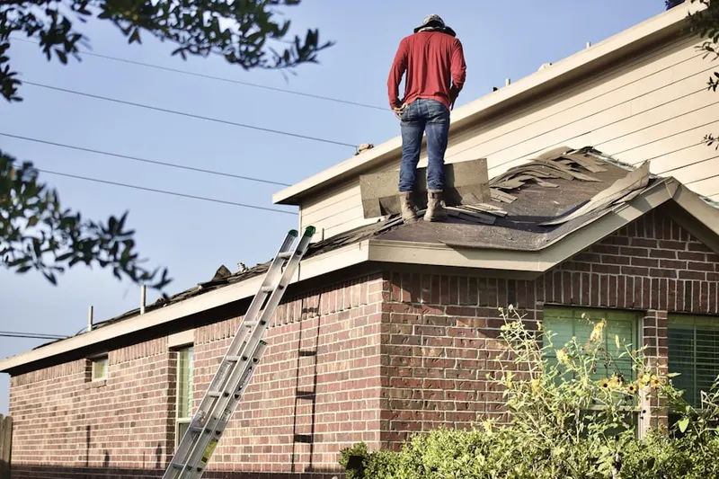 Professional roofer working on a residential roof in Robertsdale